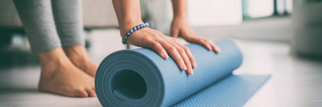 studio yoga class rolling mat