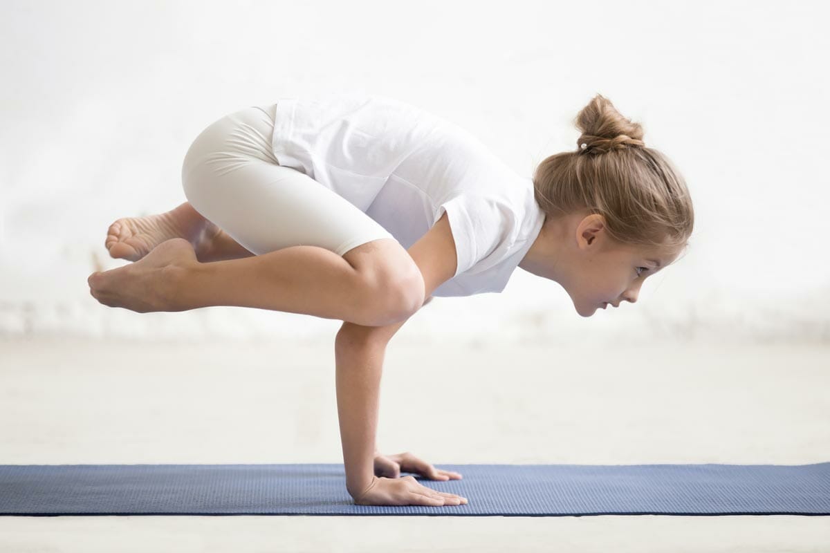 child yoga crow pose flying